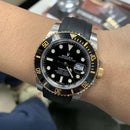 Rolex black bicolour submariner with black strap